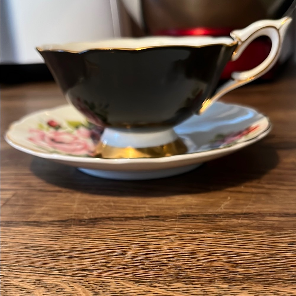 Elegant Black and Gold Teacup with Floral Saucer
